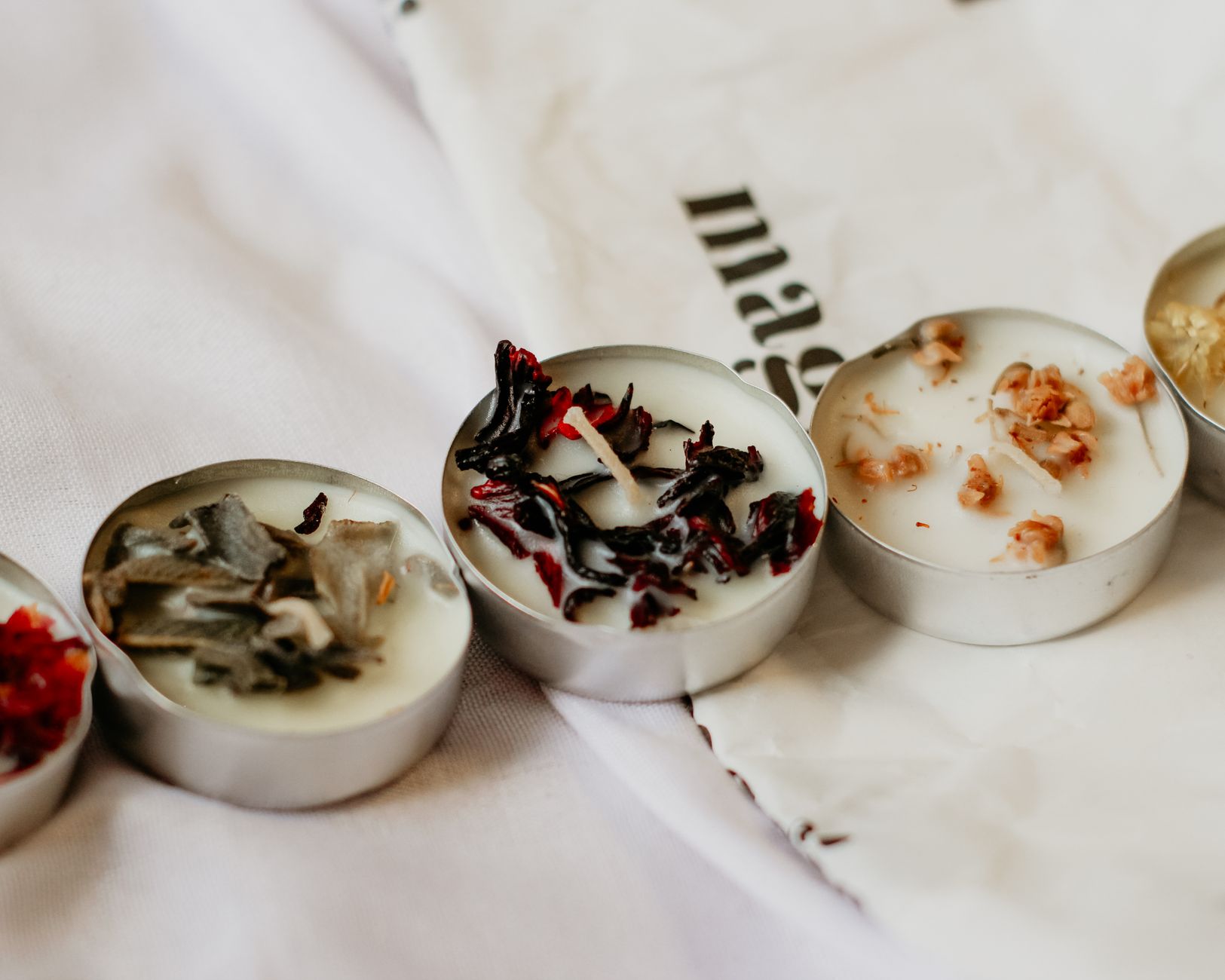 Sojowe tealighty DIY z suszonymi kwiatami i ziołami na białym tle